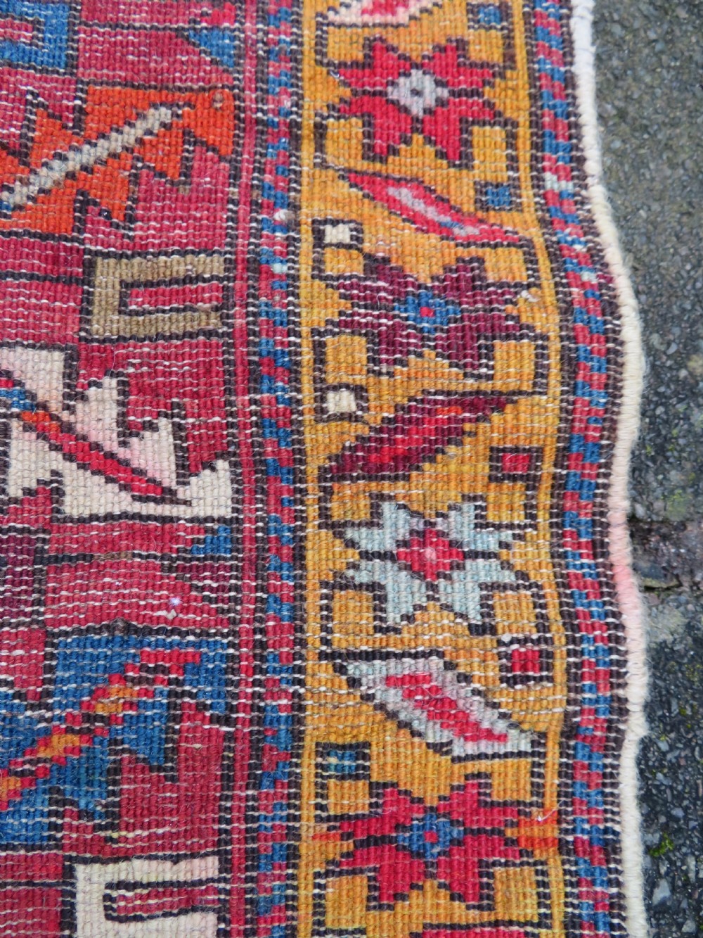 An antique late 19th-century Caucasian Kuba Konagkend wool rug featuring red geometric medallions set against a dark navy field with multi-coloured borders. View XXVII
