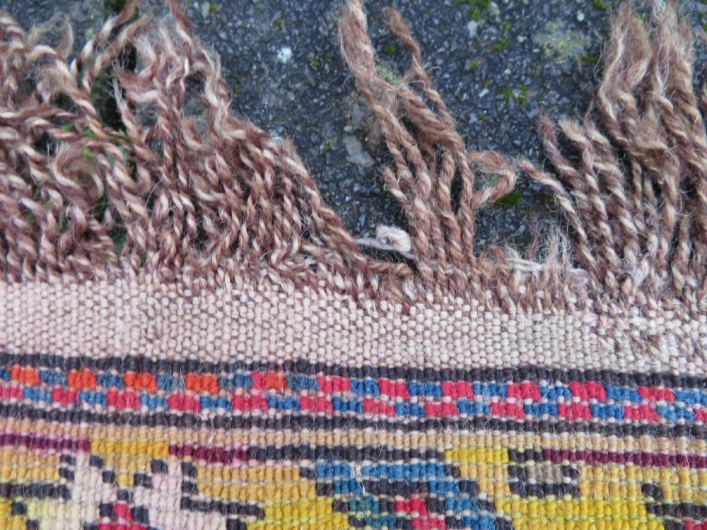 An antique late 19th-century Caucasian Kuba Konagkend wool rug featuring red geometric medallions set against a dark navy field with multi-coloured borders. View XXVIII