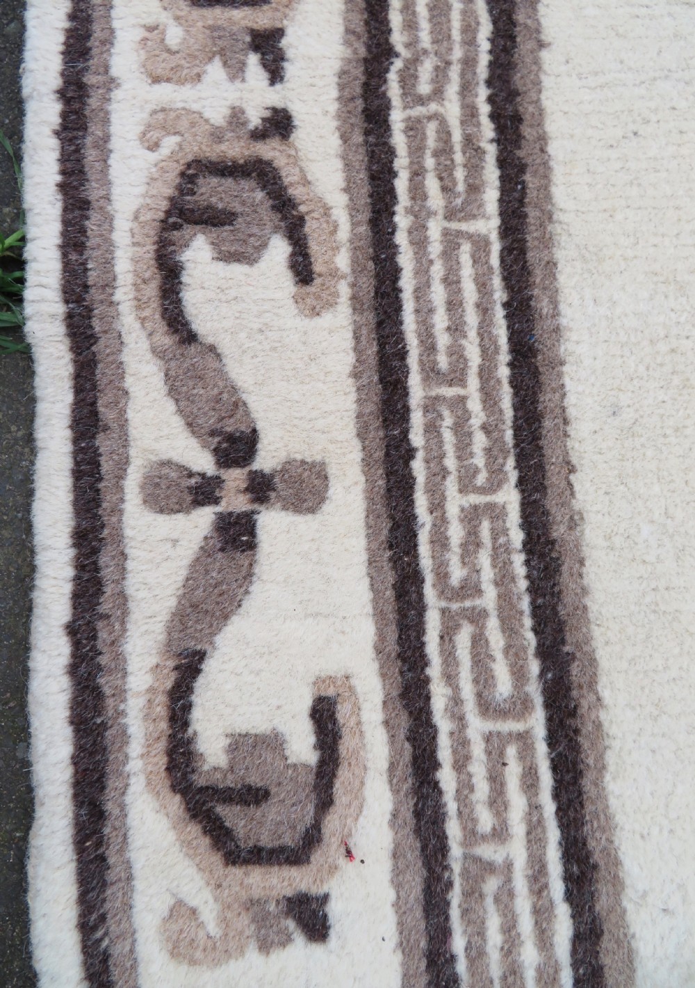 A rectangular hand-knotted wool rug runner featuring three central brown circular medallions on a cream background with a geometric border. View XIII