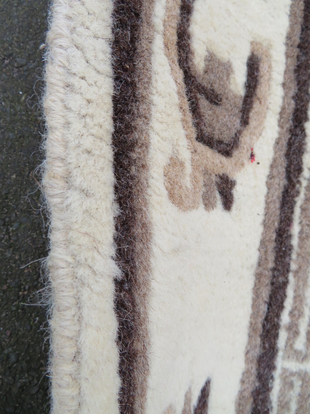 A rectangular hand-knotted wool rug runner featuring three central brown circular medallions on a cream background with a geometric border. View XIV
