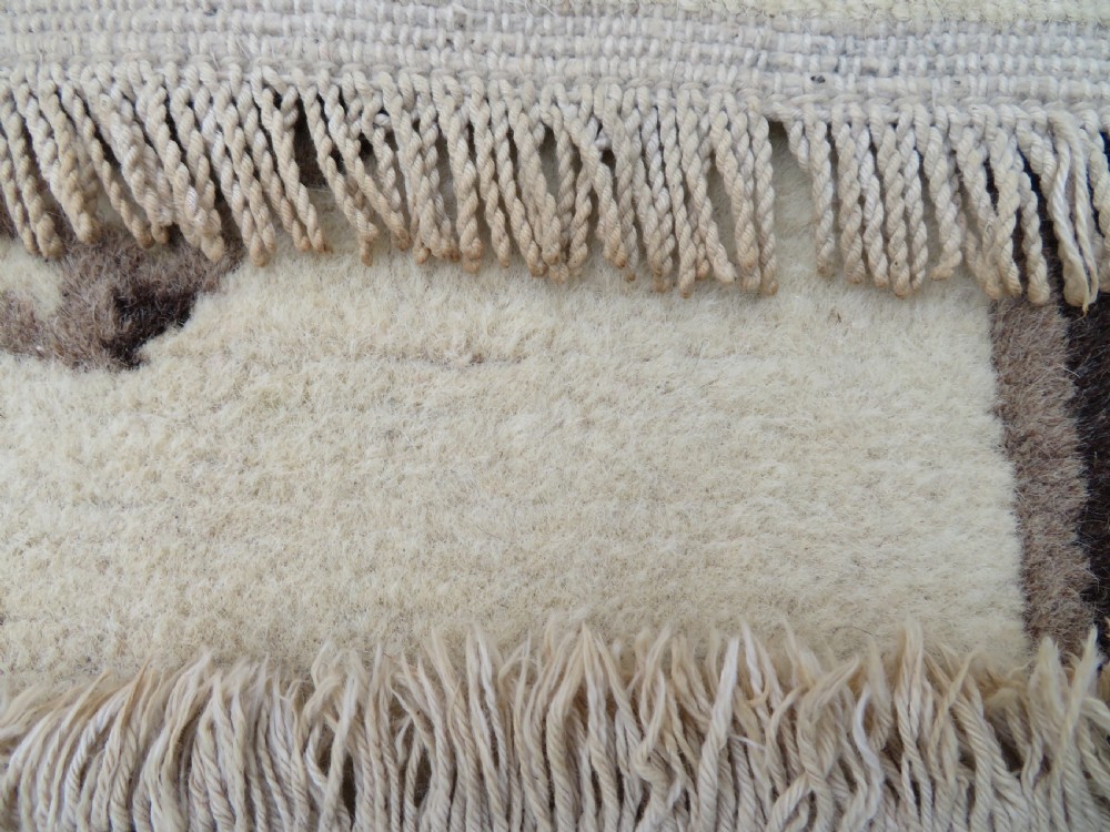 A rectangular hand-knotted wool rug runner featuring three central brown circular medallions on a cream background with a geometric border. View XVIII