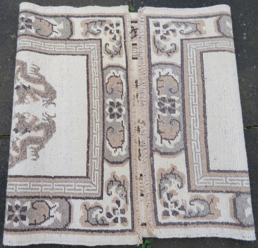 A rectangular hand-knotted cream wool rug featuring two central dragon medallions, a key meander border, and grey decorative motifs. View XIV