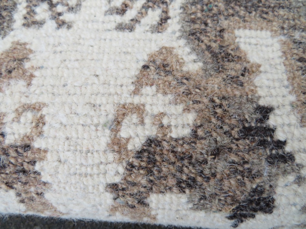 A rectangular hand-knotted cream wool rug featuring two central dragon medallions, a key meander border, and grey decorative motifs. View XV