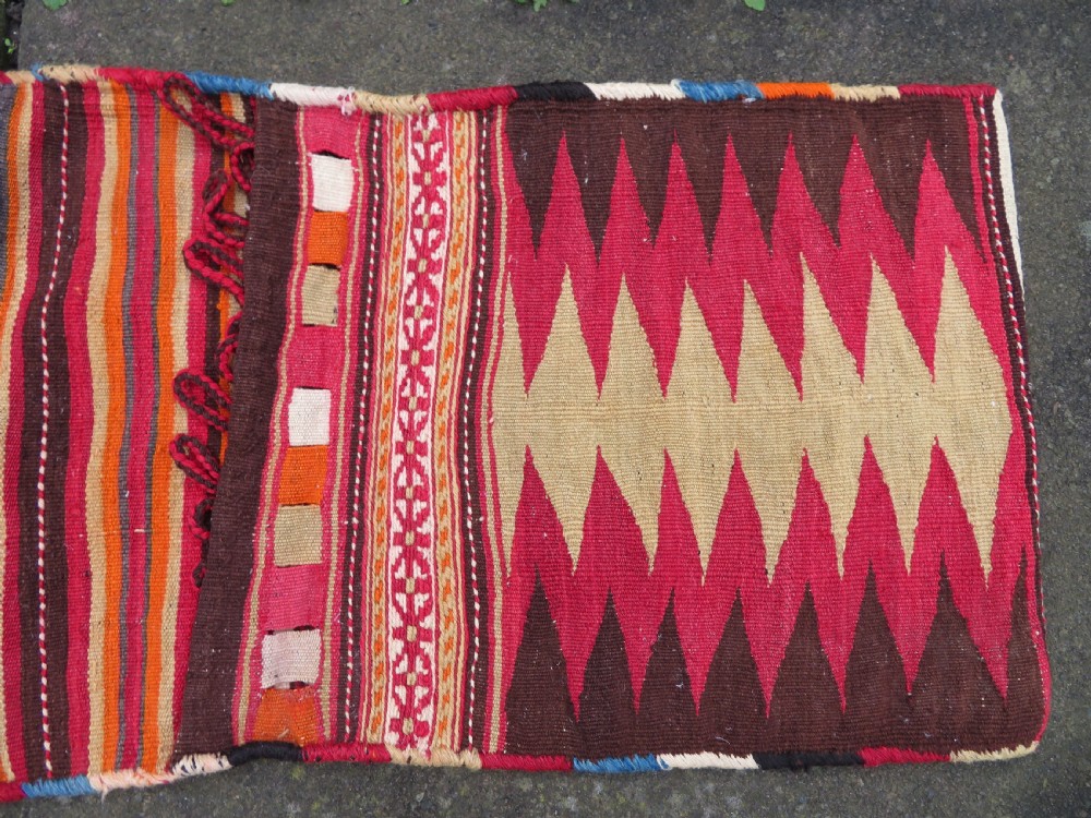 An antique woven wool Azerbaijan saddle bag displaying geometric serrated motifs in red, cream, and dark brown. View II