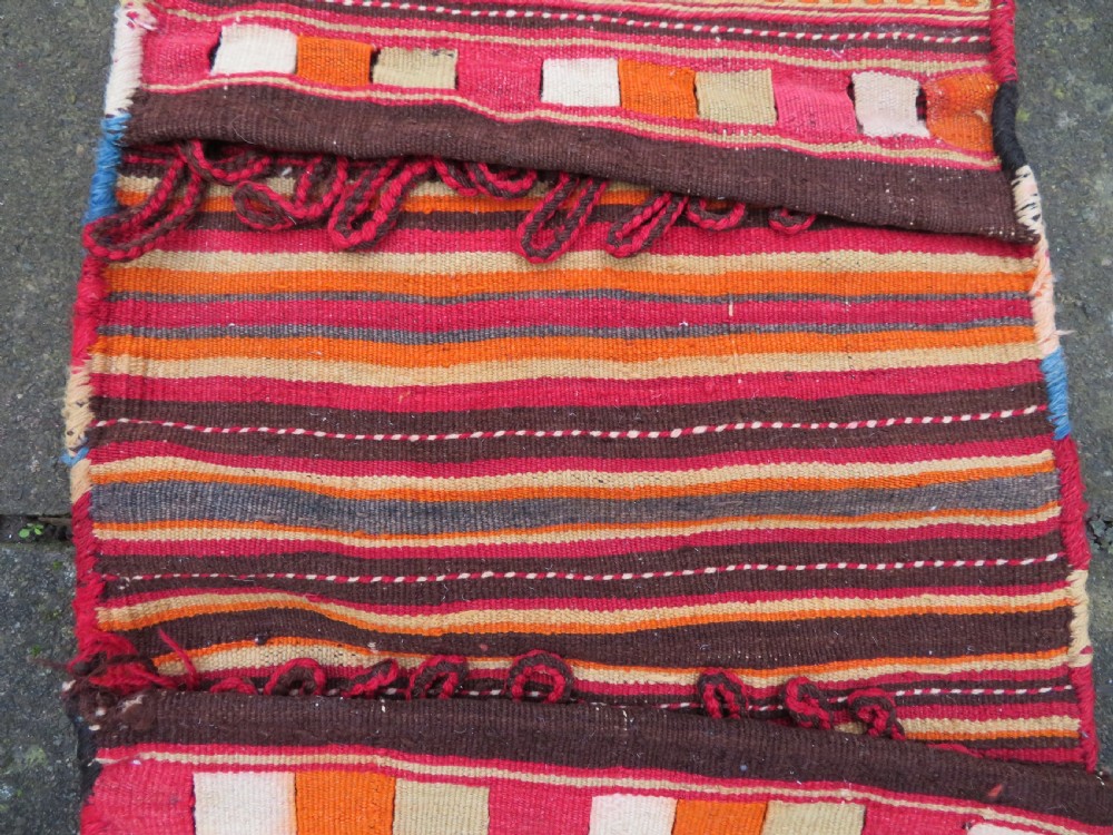 An antique woven wool Azerbaijan saddle bag displaying geometric serrated motifs in red, cream, and dark brown. View VI