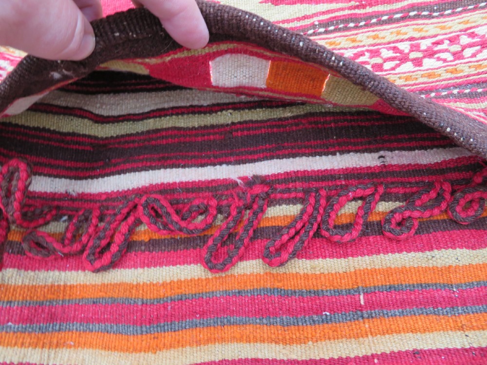 An antique woven wool Azerbaijan saddle bag displaying geometric serrated motifs in red, cream, and dark brown. View VII