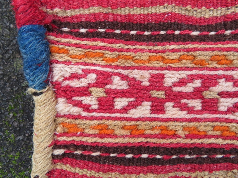An antique woven wool Azerbaijan saddle bag displaying geometric serrated motifs in red, cream, and dark brown. View IX