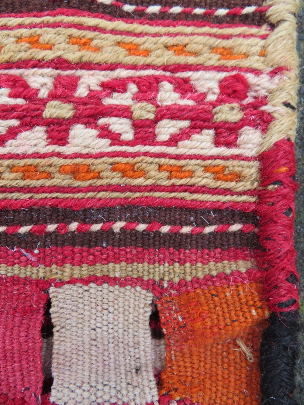An antique woven wool Azerbaijan saddle bag displaying geometric serrated motifs in red, cream, and dark brown. View XII