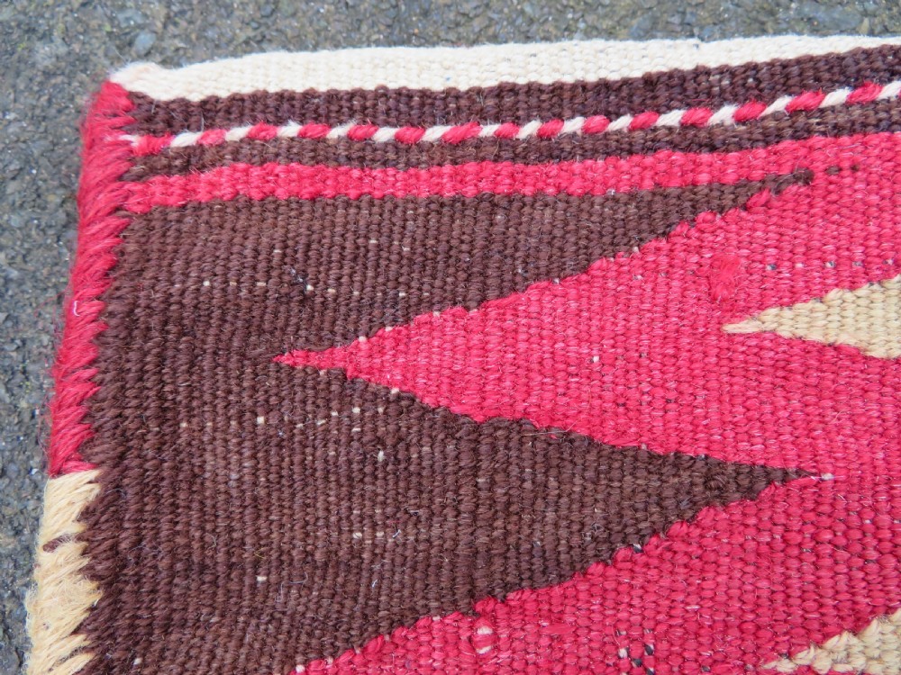 An antique woven wool Azerbaijan saddle bag displaying geometric serrated motifs in red, cream, and dark brown. View XIII