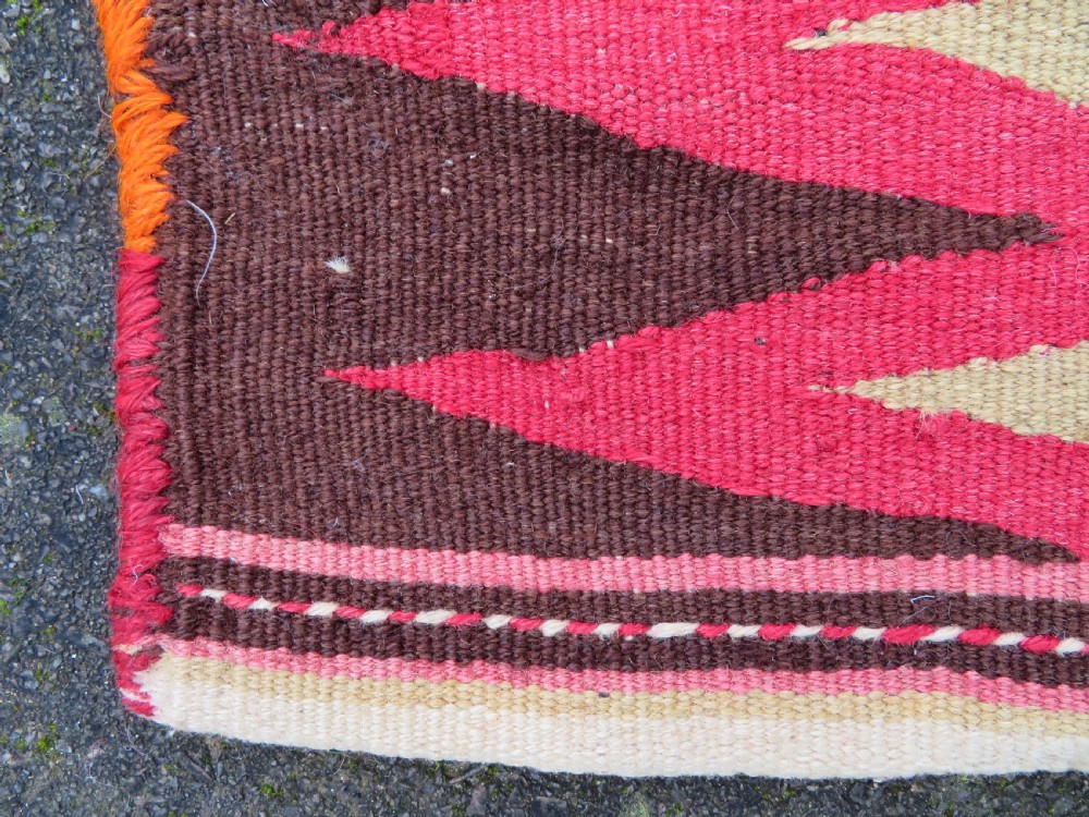 An antique woven wool Azerbaijan saddle bag displaying geometric serrated motifs in red, cream, and dark brown. View XIV