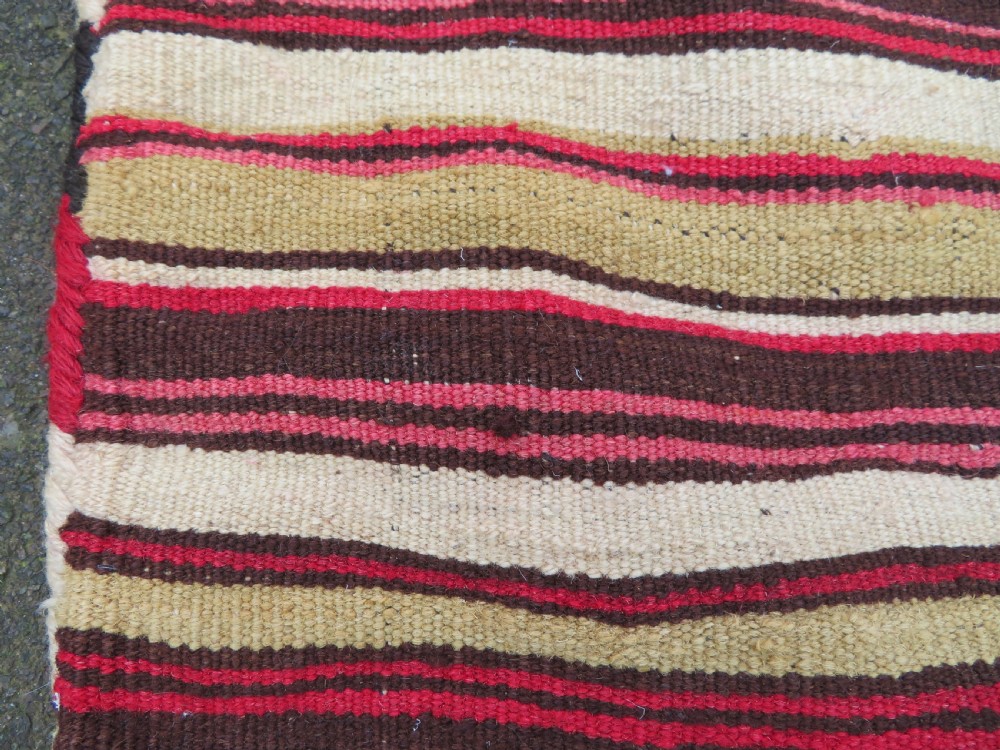 An antique woven wool Azerbaijan saddle bag displaying geometric serrated motifs in red, cream, and dark brown. View XVIII