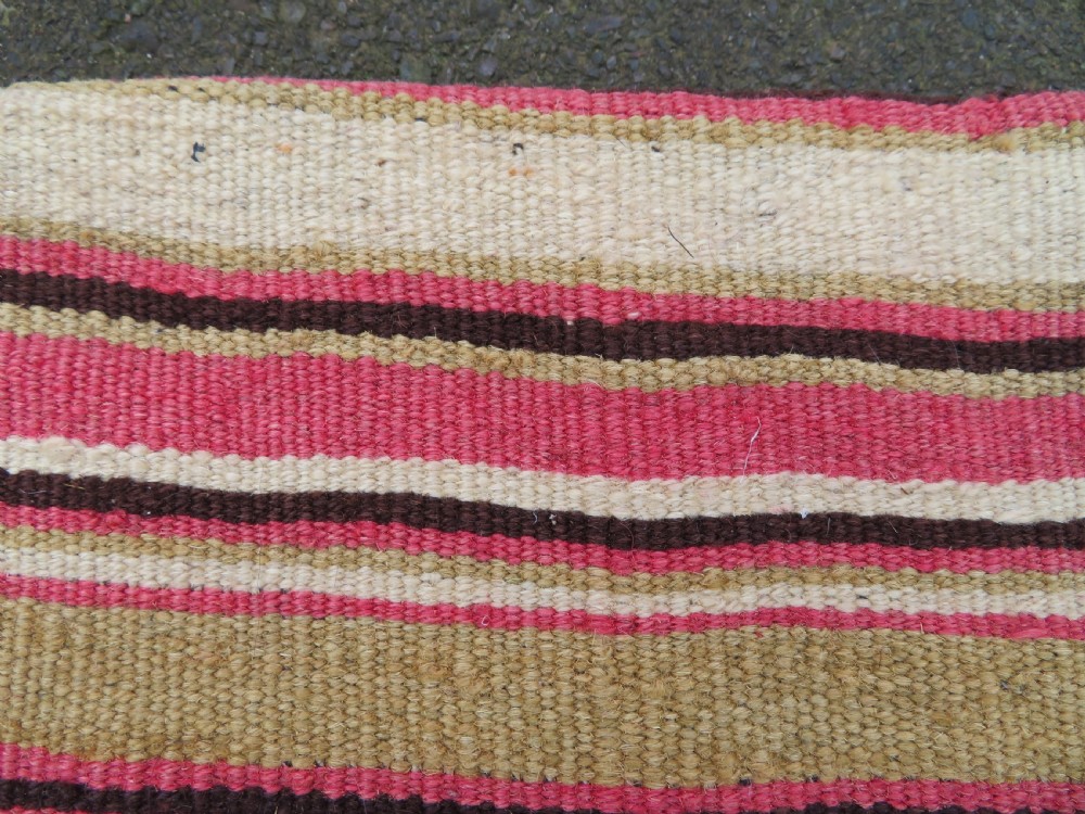 An antique woven wool Azerbaijan saddle bag displaying geometric serrated motifs in red, cream, and dark brown. View XIX