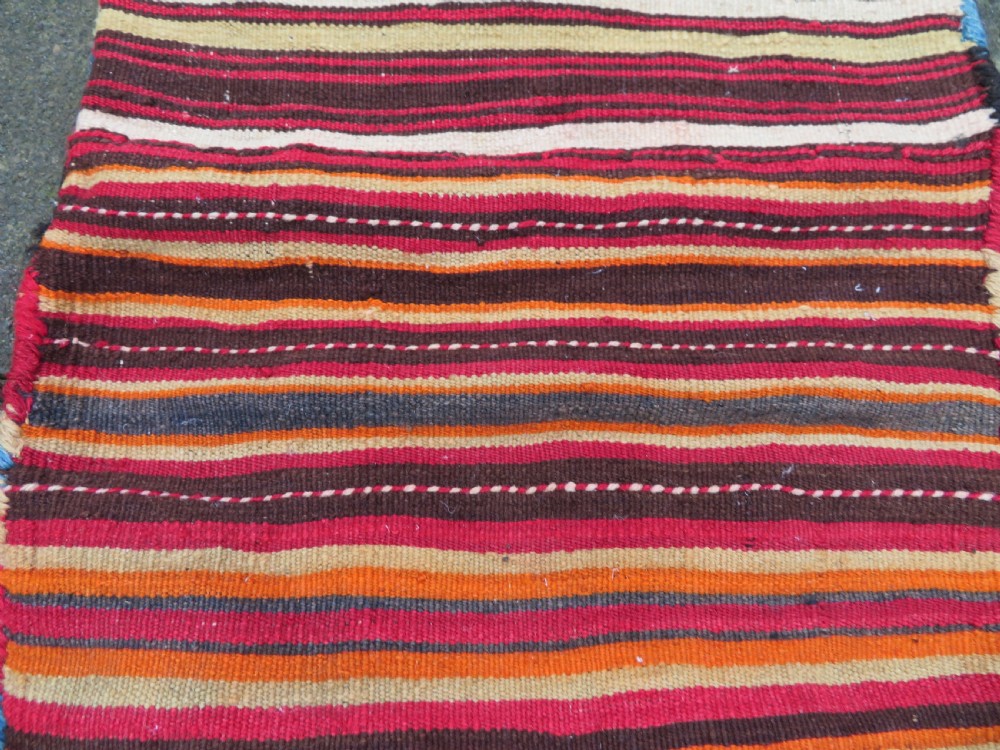 An antique woven wool Azerbaijan saddle bag displaying geometric serrated motifs in red, cream, and dark brown. View XXI
