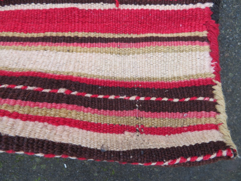 An antique woven wool Azerbaijan saddle bag displaying geometric serrated motifs in red, cream, and dark brown. View XXII