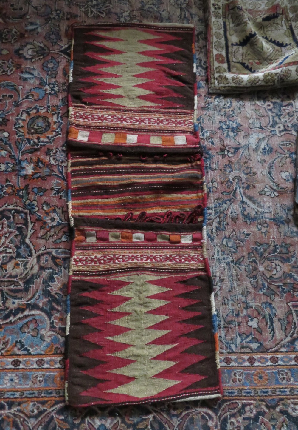 An antique woven wool Azerbaijan saddle bag displaying geometric serrated motifs in red, cream, and dark brown. View XXVII