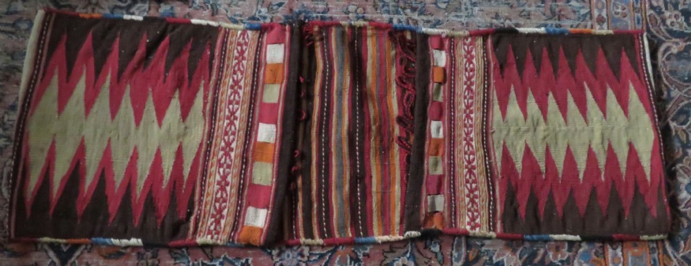An antique woven wool Azerbaijan saddle bag displaying geometric serrated motifs in red, cream, and dark brown. View XXVIII