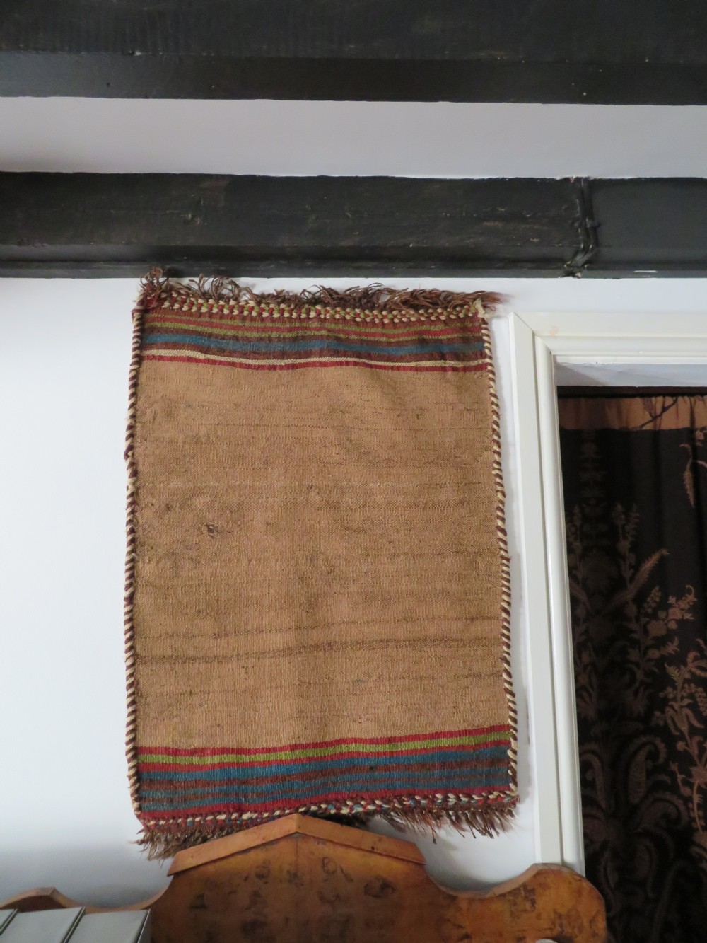 An antique flatweave rug featuring a central undyed tan wool field flanked by colourful horizontal striped end bands and braided fringe edges. View XXI