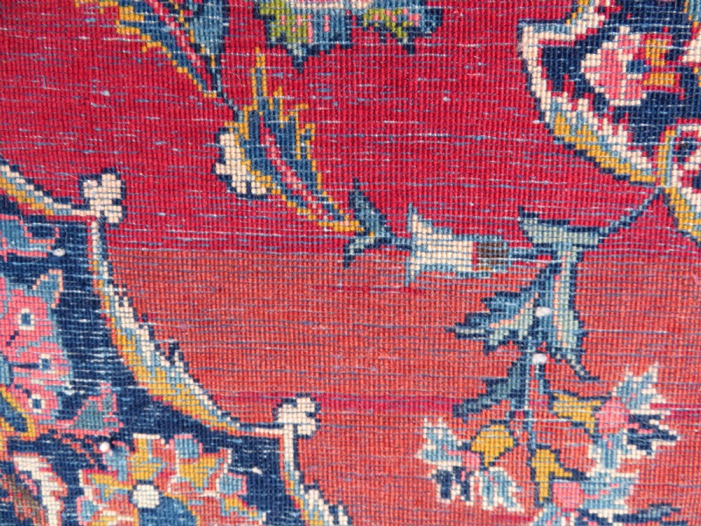 A hand-knotted Persian Kashan wool rug featuring a central navy and cream floral medallion on a rose pink field surrounded by floral spandrels and a navy border. View VII