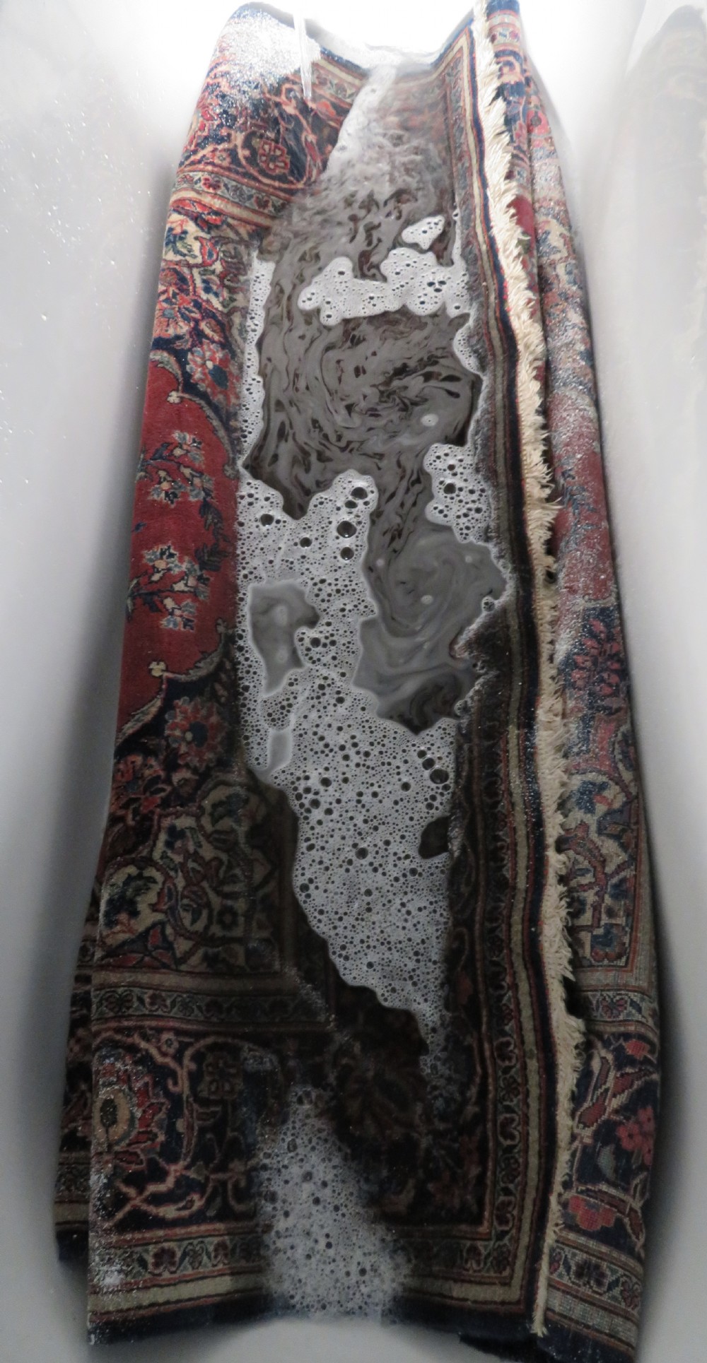 A hand-knotted Persian Kashan wool rug featuring a central navy and cream floral medallion on a rose pink field surrounded by floral spandrels and a navy border. View XXVIII