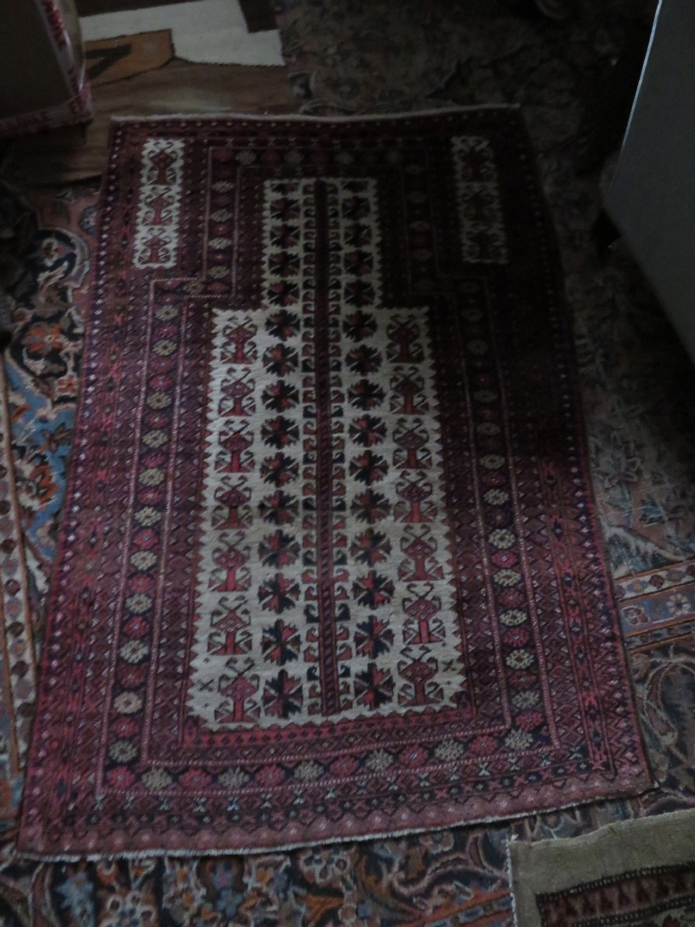 An antique hand-knotted Baluch wool rug featuring a central tree of life design on a cream field surrounded by red and navy geometric borders. View XXII