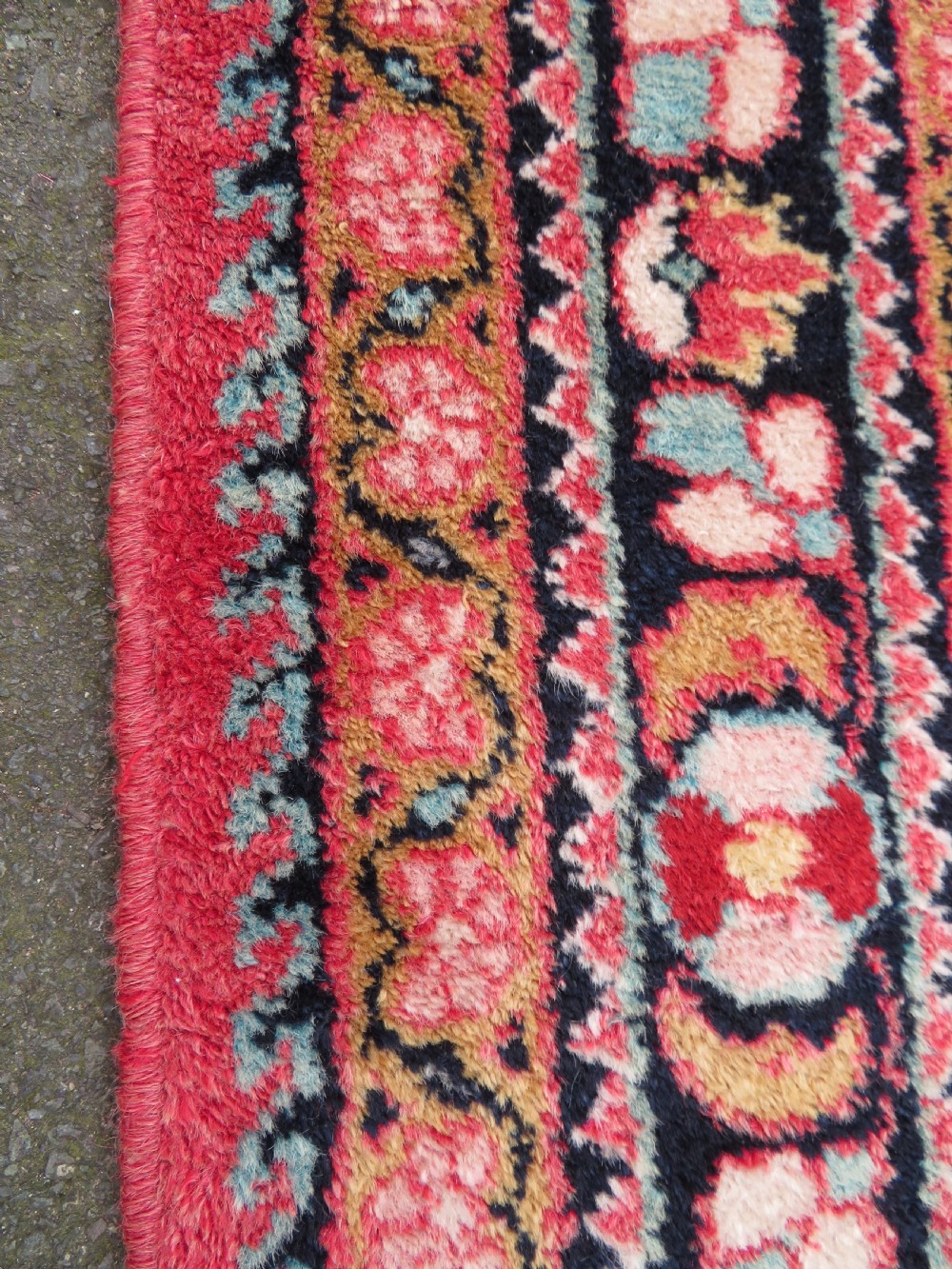 An antique Jozan Persian rug featuring a central floral medallion on a rose red field surrounded by intricate spandrels and multi-band patterned borders. View XI