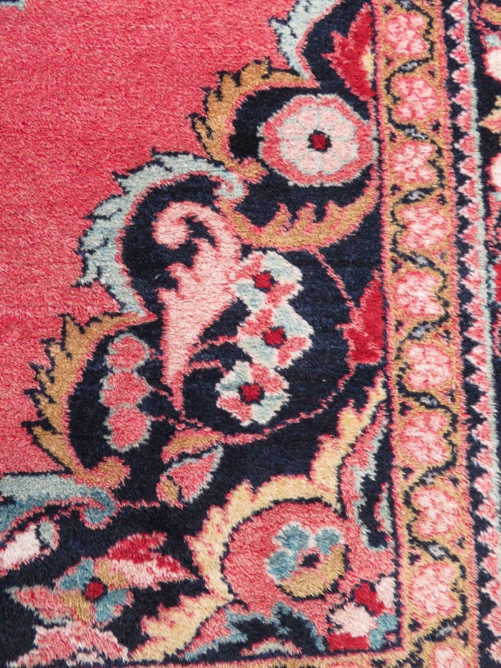 An antique Jozan Persian rug featuring a central floral medallion on a rose red field surrounded by intricate spandrels and multi-band patterned borders. View XIII