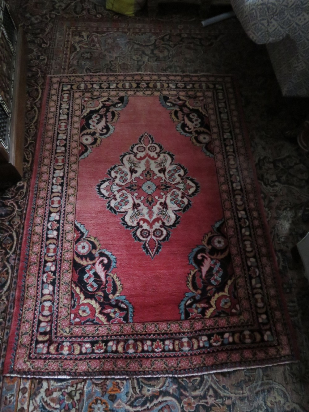 An antique Jozan Persian rug featuring a central floral medallion on a rose red field surrounded by intricate spandrels and multi-band patterned borders. View XIX