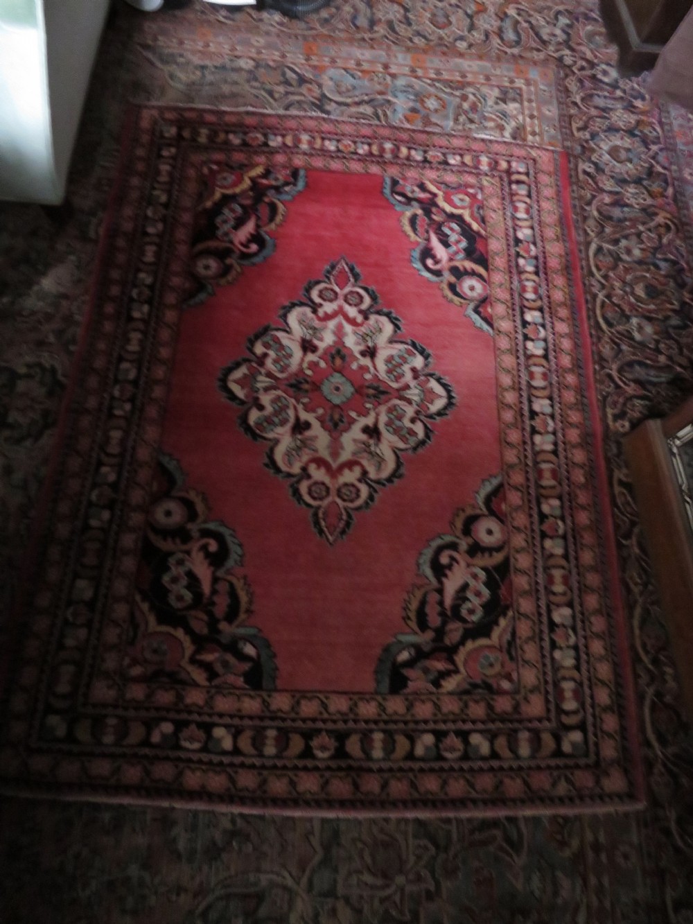 An antique Jozan Persian rug featuring a central floral medallion on a rose red field surrounded by intricate spandrels and multi-band patterned borders. View XX