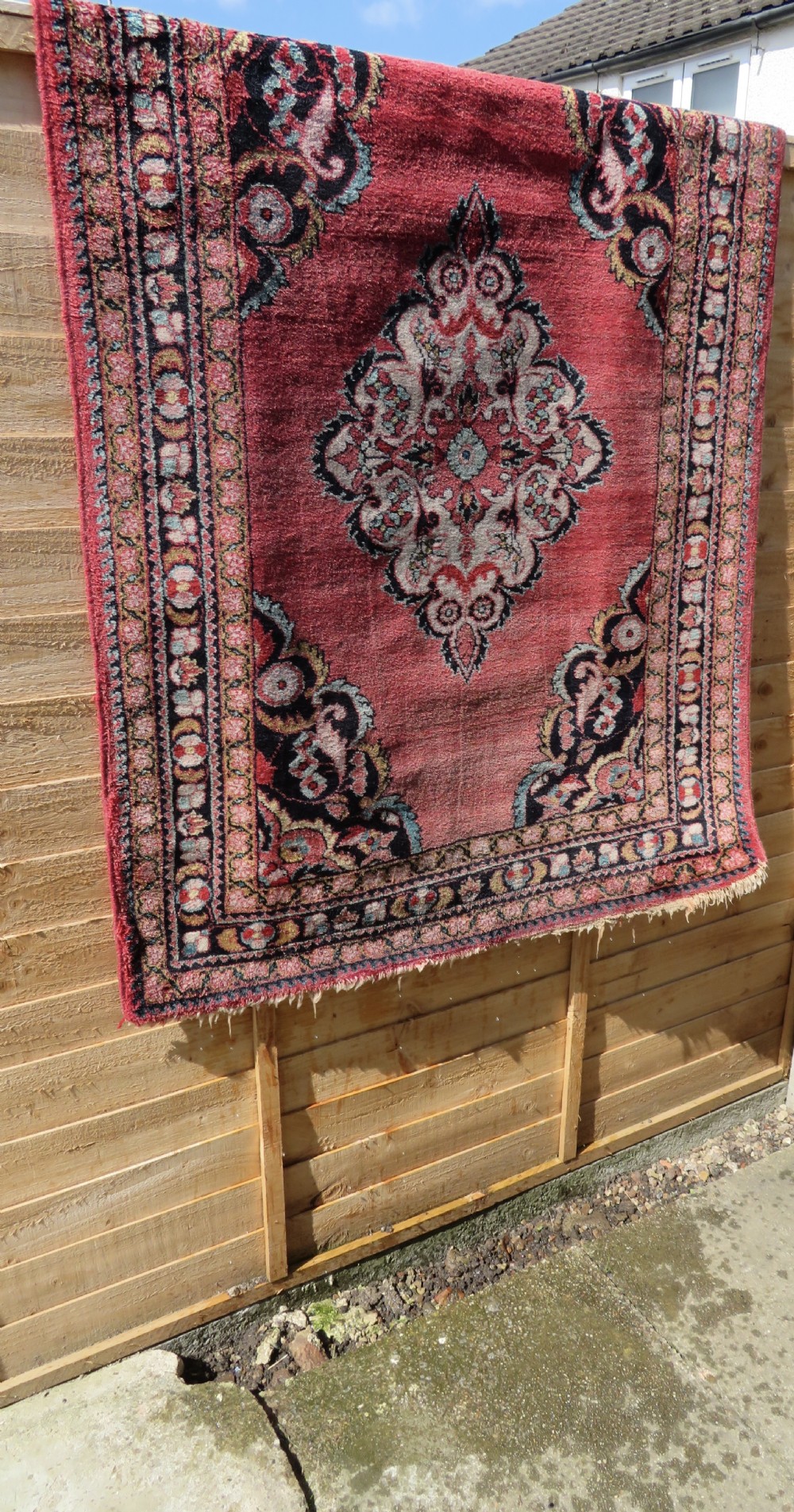 An antique Jozan Persian rug featuring a central floral medallion on a rose red field surrounded by intricate spandrels and multi-band patterned borders. View XXIII