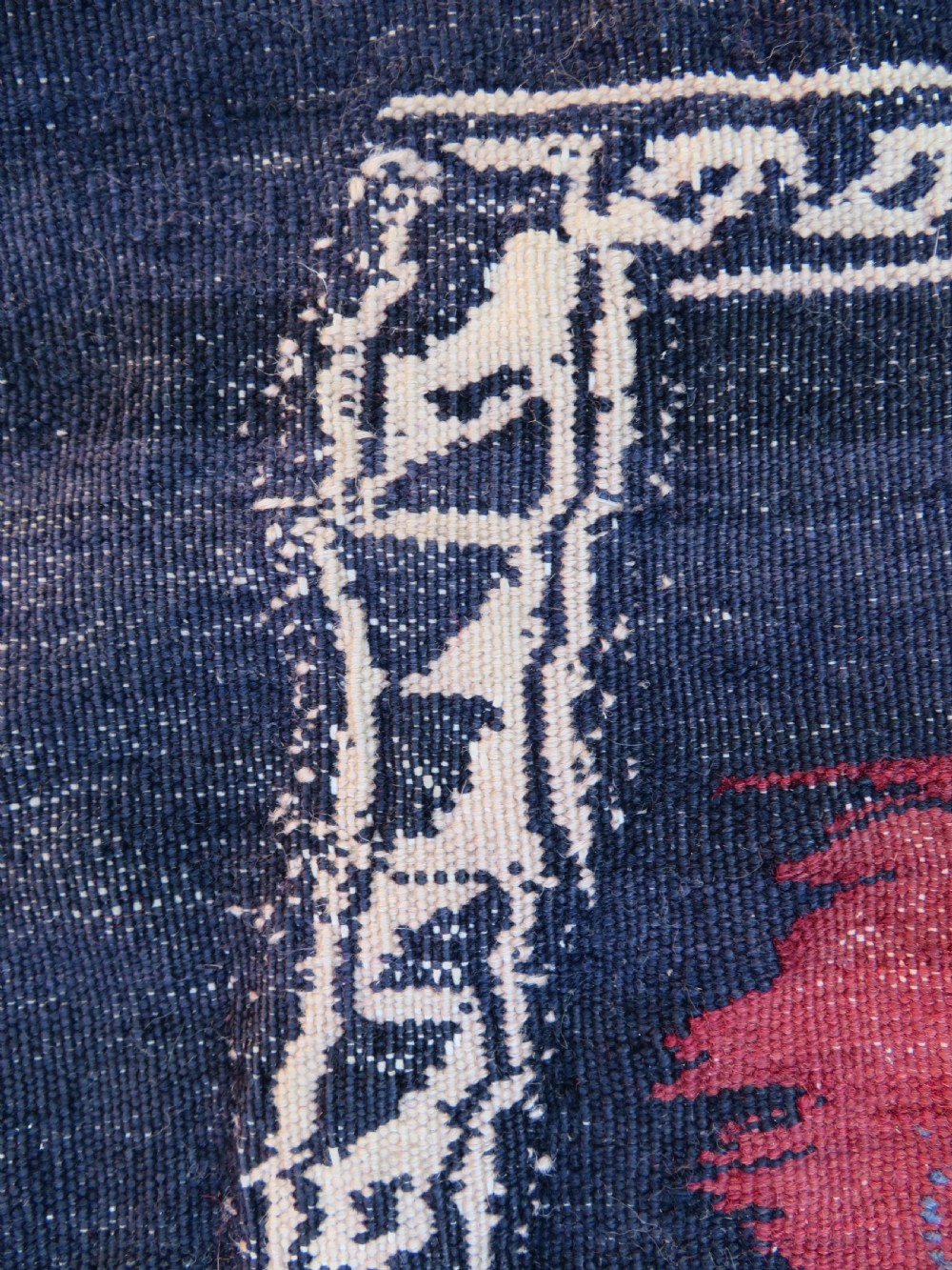 Square flatwoven antique Afshar sofreh rug featuring a central pink diamond medallion framed by nested red and navy blue stepped geometric borders. View X