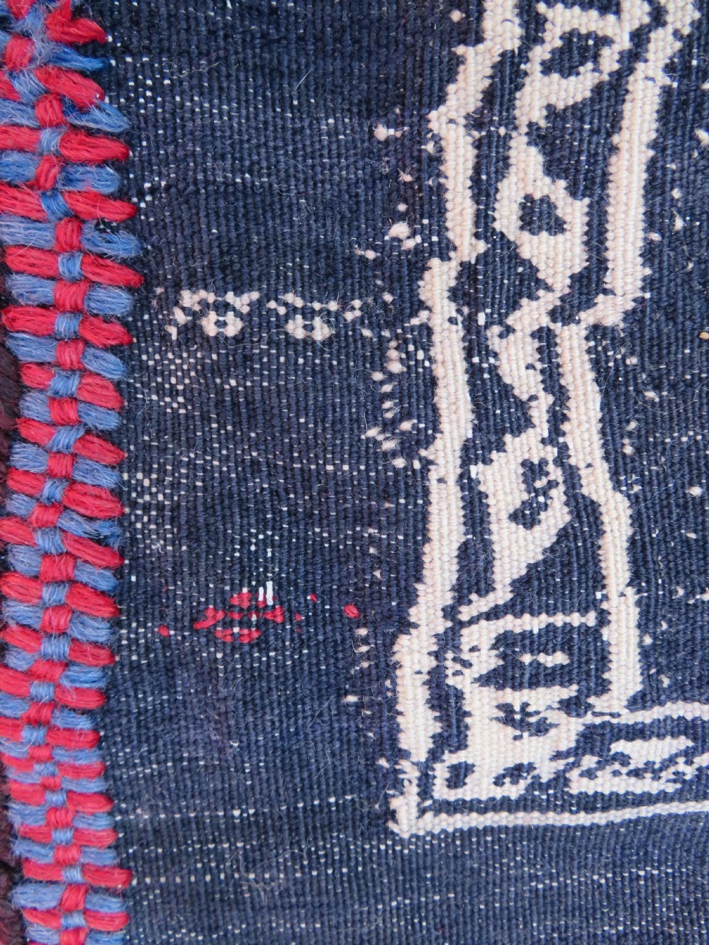Square flatwoven antique Afshar sofreh rug featuring a central pink diamond medallion framed by nested red and navy blue stepped geometric borders. View XIII