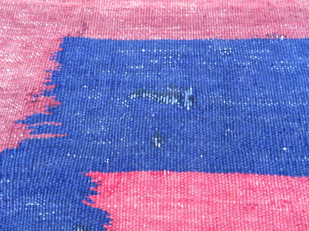 Square flatwoven antique Afshar sofreh rug featuring a central pink diamond medallion framed by nested red and navy blue stepped geometric borders. View XV