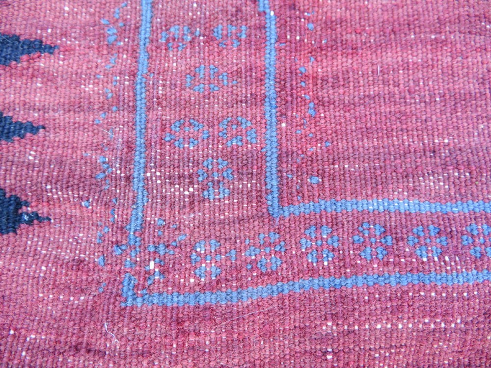 Square flatwoven antique Afshar sofreh rug featuring a central pink diamond medallion framed by nested red and navy blue stepped geometric borders. View XVI