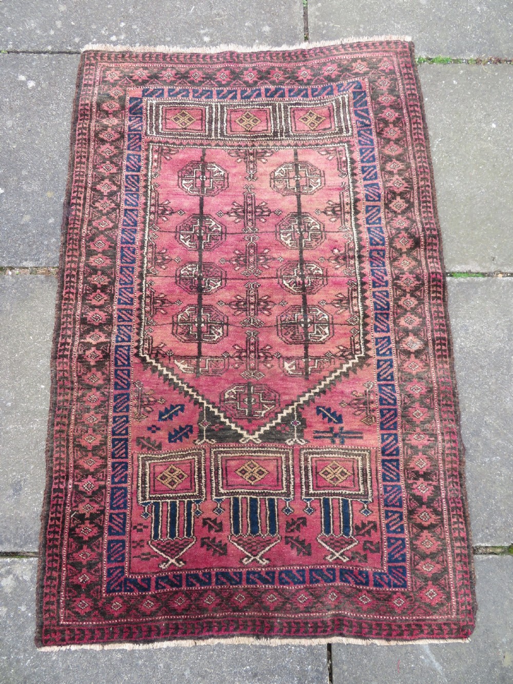An antique hand-knotted Turkmen Kizil Ayak wool prayer rug featuring a triple mihrab arch design in deep red, dark blue, and charcoal shades. View II