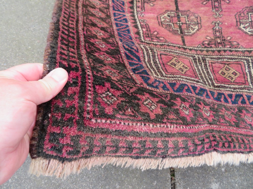 An antique hand-knotted Turkmen Kizil Ayak wool prayer rug featuring a triple mihrab arch design in deep red, dark blue, and charcoal shades. View VIII