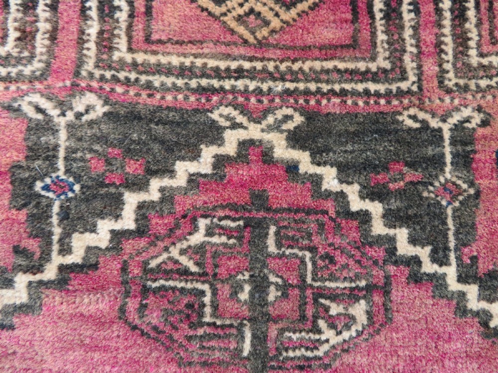 An antique hand-knotted Turkmen Kizil Ayak wool prayer rug featuring a triple mihrab arch design in deep red, dark blue, and charcoal shades. View XII