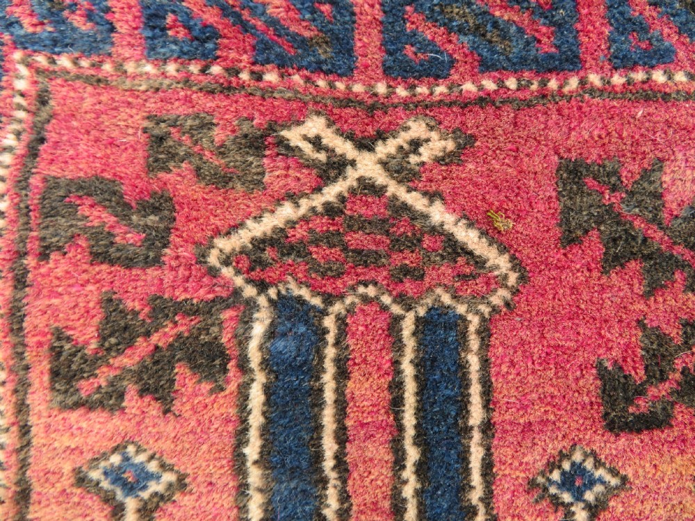An antique hand-knotted Turkmen Kizil Ayak wool prayer rug featuring a triple mihrab arch design in deep red, dark blue, and charcoal shades. View XIII