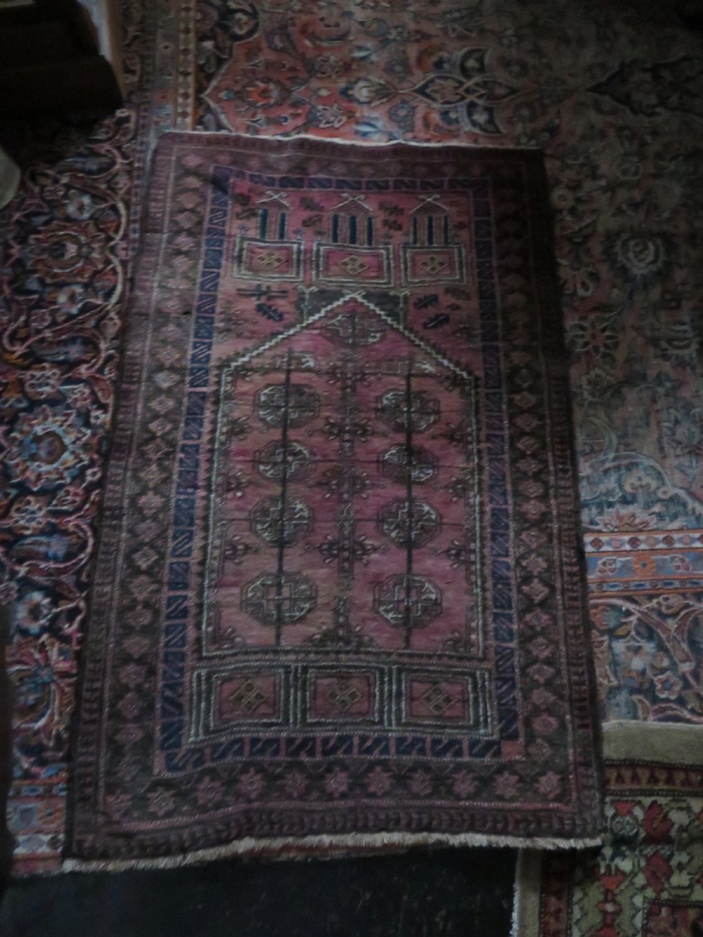 An antique hand-knotted Turkmen Kizil Ayak wool prayer rug featuring a triple mihrab arch design in deep red, dark blue, and charcoal shades. View XVIII