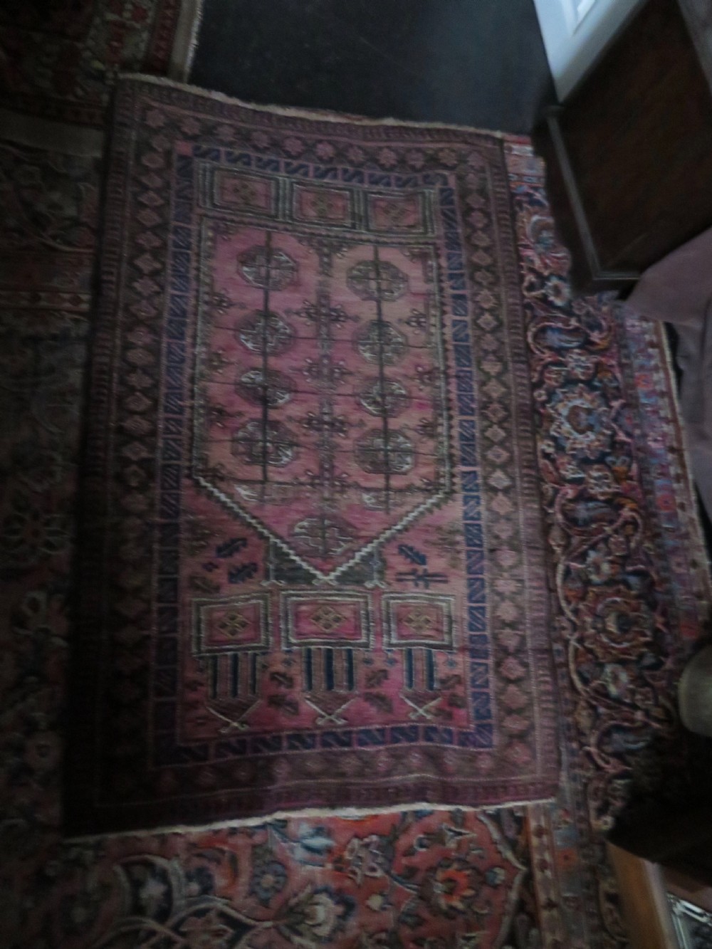 An antique hand-knotted Turkmen Kizil Ayak wool prayer rug featuring a triple mihrab arch design in deep red, dark blue, and charcoal shades. View XIX
