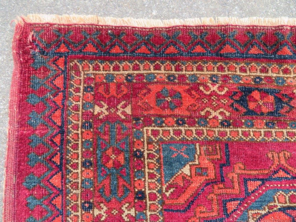 A mid-nineteenth-century hand-knotted Tekke Turkmen wool chuval face featuring six octagonal guls on a deep crimson ground with an intricate bottom elem border. View VIII