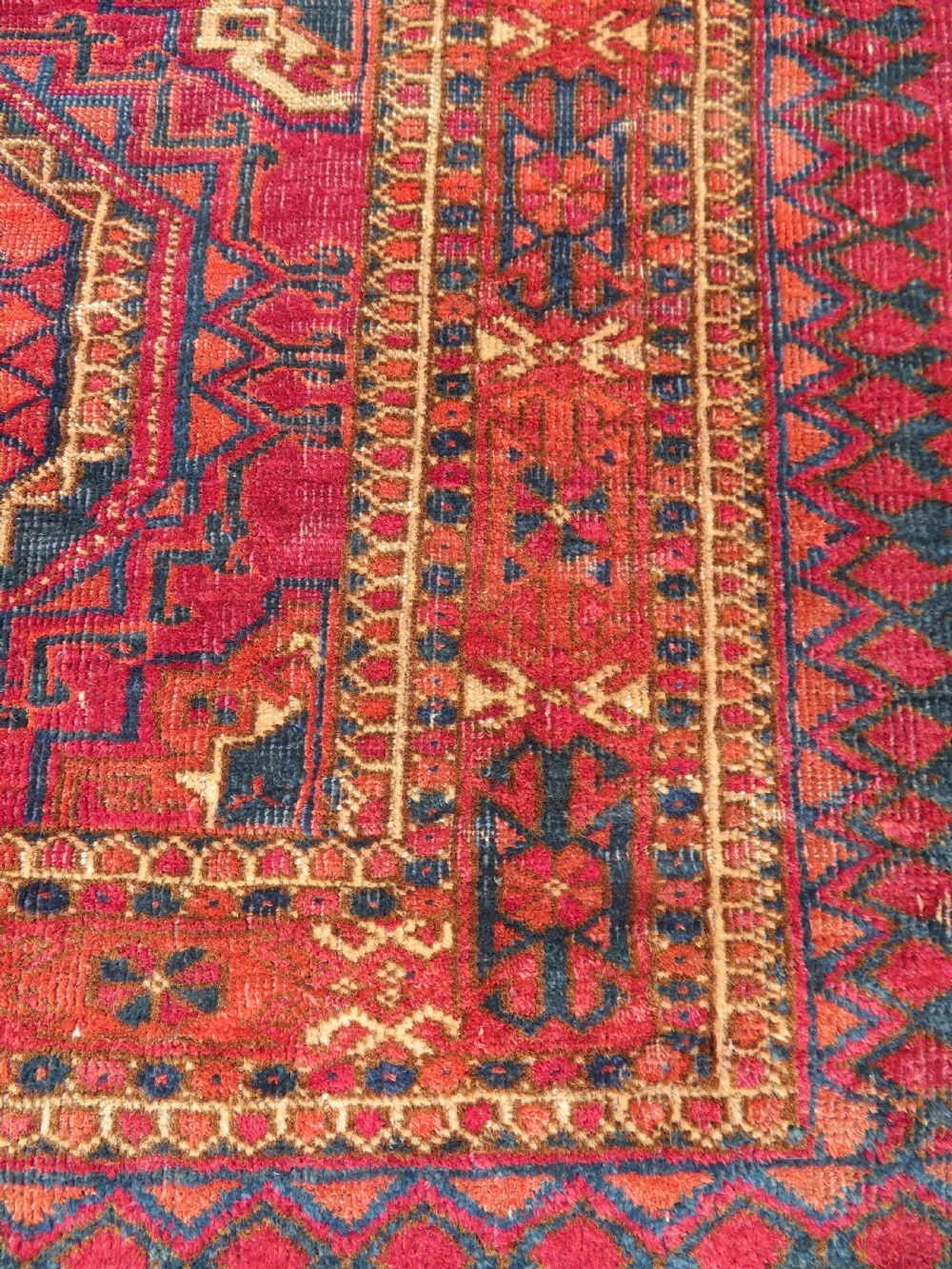 A mid-nineteenth-century hand-knotted Tekke Turkmen wool chuval face featuring six octagonal guls on a deep crimson ground with an intricate bottom elem border. View XI