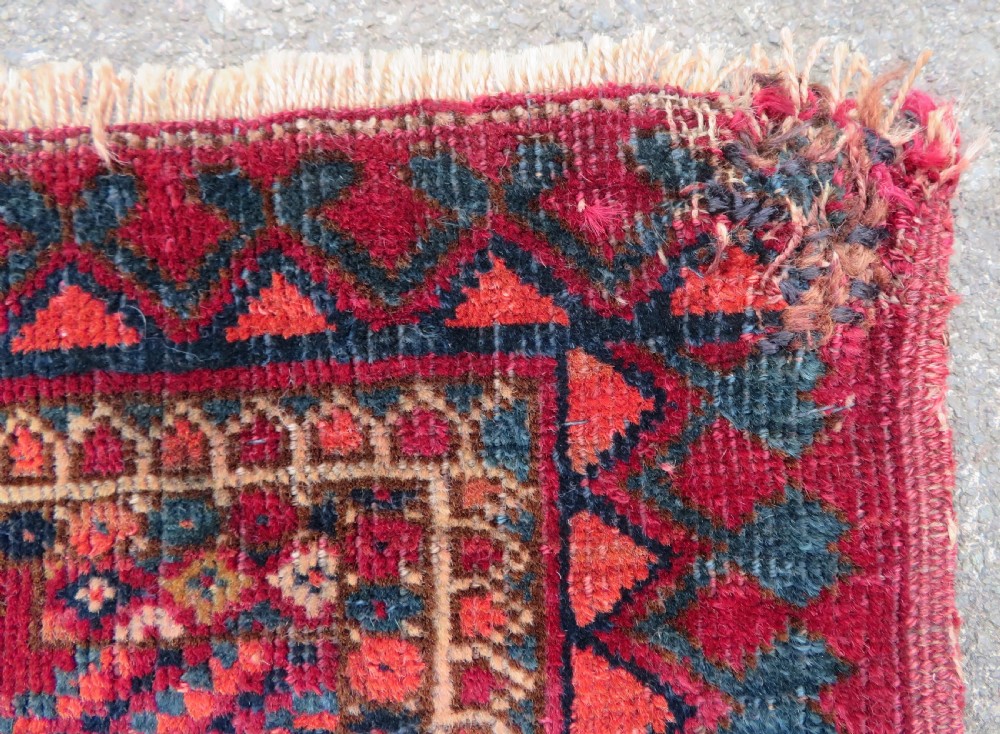 A mid-nineteenth-century hand-knotted Tekke Turkmen wool chuval face featuring six octagonal guls on a deep crimson ground with an intricate bottom elem border. View XIV