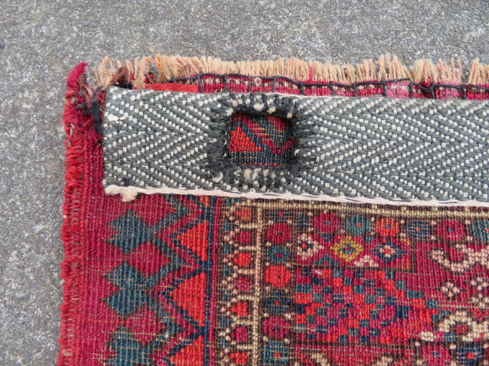 A mid-nineteenth-century hand-knotted Tekke Turkmen wool chuval face featuring six octagonal guls on a deep crimson ground with an intricate bottom elem border. View XVI