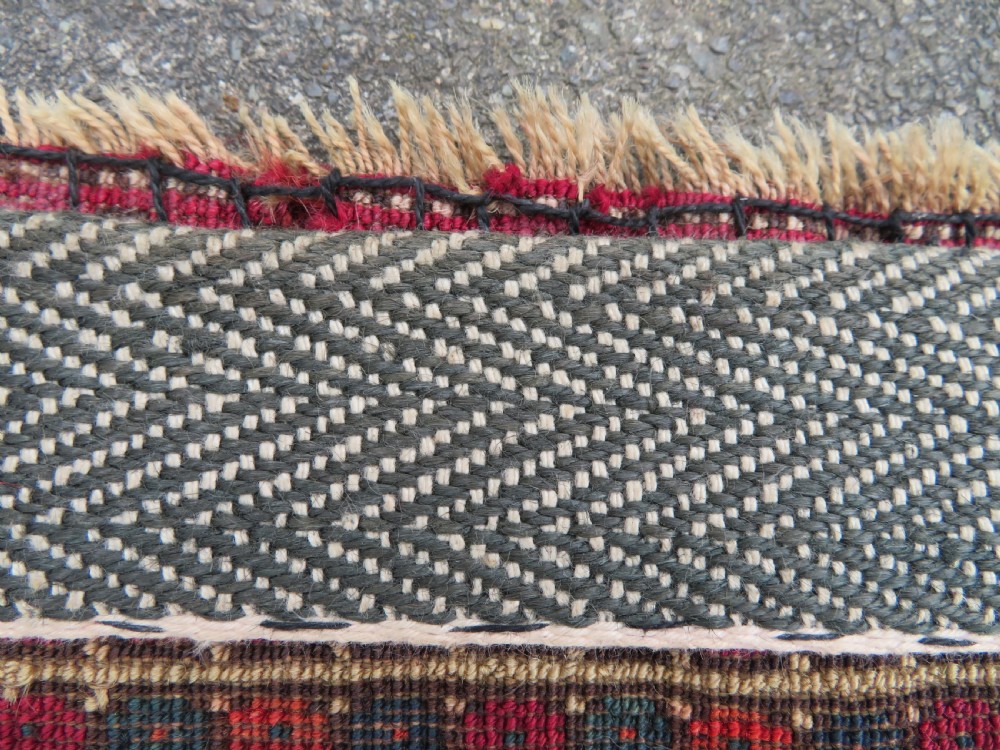 A mid-nineteenth-century hand-knotted Tekke Turkmen wool chuval face featuring six octagonal guls on a deep crimson ground with an intricate bottom elem border. View XVII