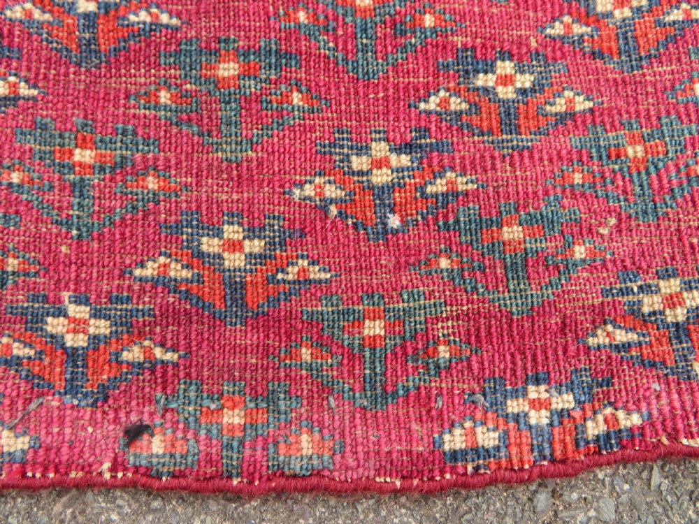 A mid-nineteenth-century hand-knotted Tekke Turkmen wool chuval face featuring six octagonal guls on a deep crimson ground with an intricate bottom elem border. View XVIII