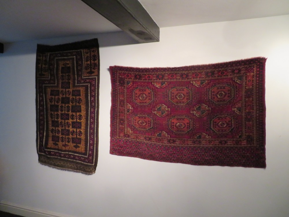 A mid-nineteenth-century hand-knotted Tekke Turkmen wool chuval face featuring six octagonal guls on a deep crimson ground with an intricate bottom elem border. View XIX
