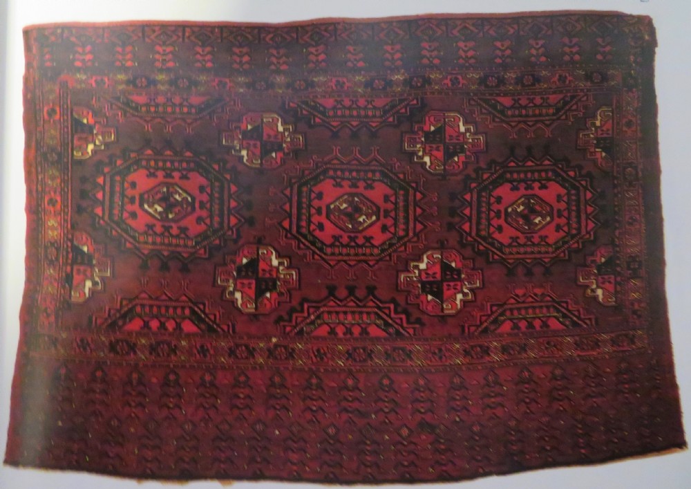 A mid-nineteenth-century hand-knotted Tekke Turkmen wool chuval face featuring six octagonal guls on a deep crimson ground with an intricate bottom elem border. View XXII
