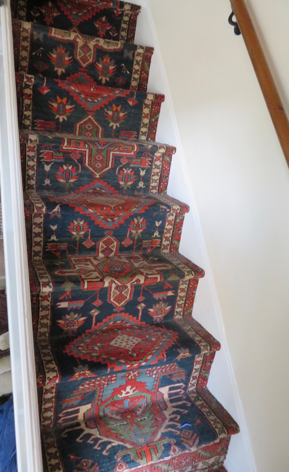 An antique North West Persian Kurdish hand-knotted wool narrow hallway runner featuring repeating diamond medallions in terracotta red, brown, and cream tones. View XVIII