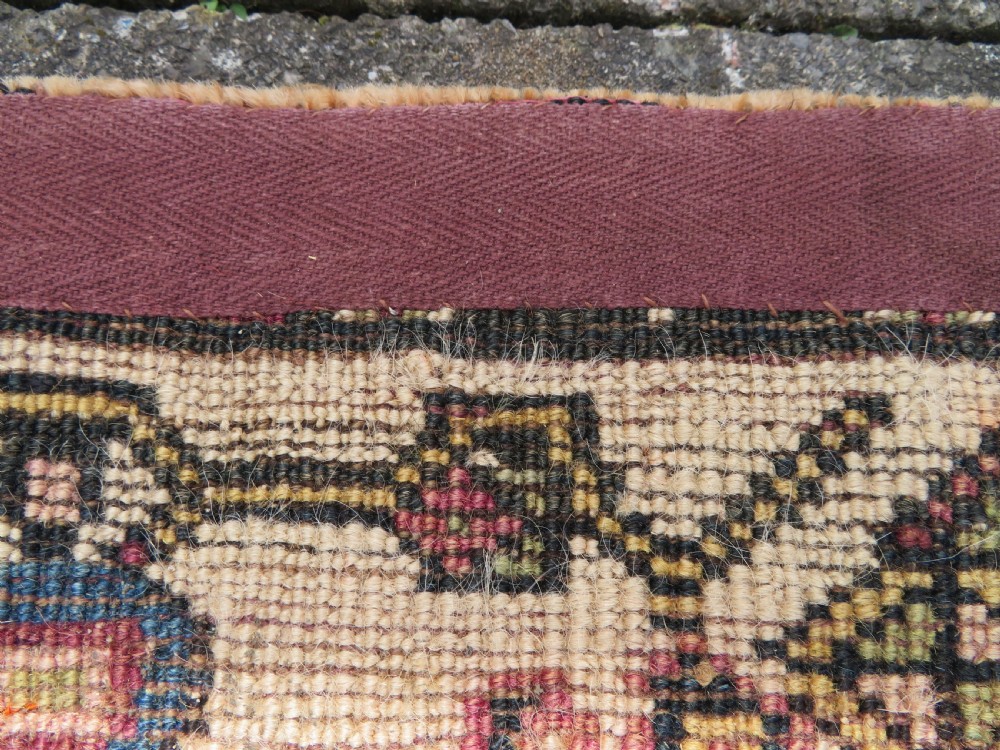 A hand-knotted antique Persian Kurdish wool runner rug with five central diamond medallions on a red field framed by a patterned ivory border. View XXIII