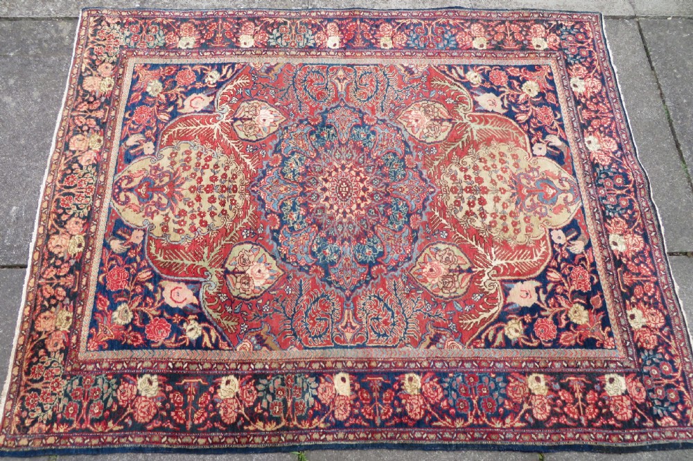 An antique hand-knotted North West Persian Tabriz rug featuring a central floral medallion surrounded by detailed terracotta red, navy blue, and cream motifs. View III